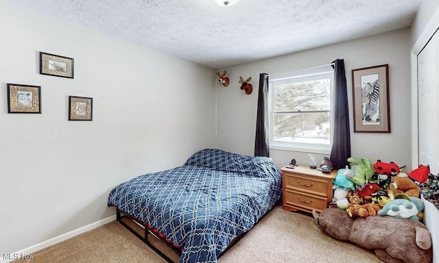 carpeted bedroom featuring a textured ceiling