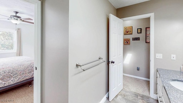 bathroom with ceiling fan and vanity