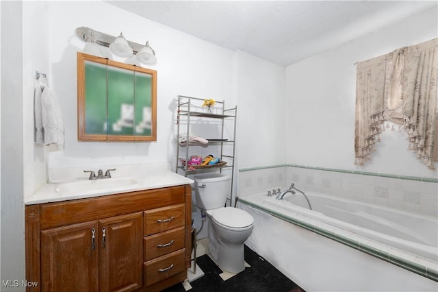 bathroom with vanity, a tub, and toilet