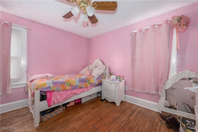 bedroom with dark wood-type flooring and ceiling fan