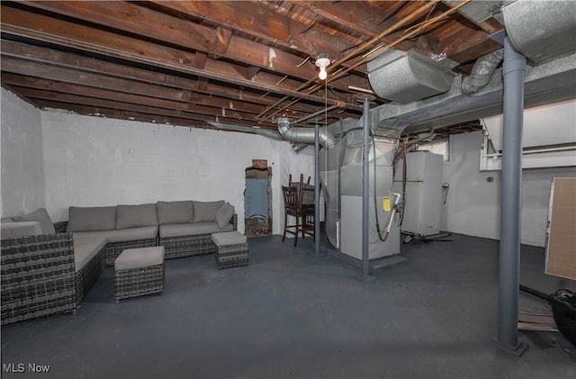 basement featuring heating unit and fridge