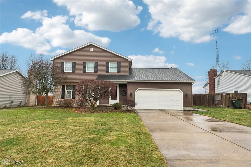 view of front property with a garage and a front yard