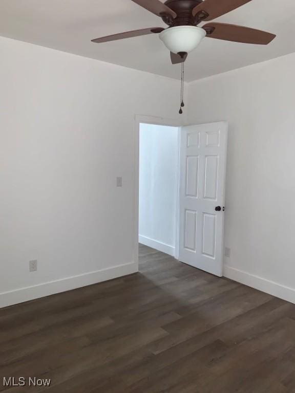 unfurnished room featuring dark hardwood / wood-style floors and ceiling fan