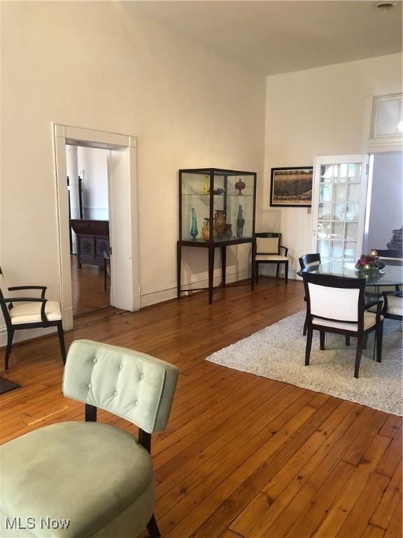 living room featuring hardwood / wood-style flooring and high vaulted ceiling