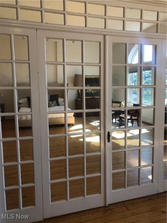 doorway to outside with wood-type flooring and french doors