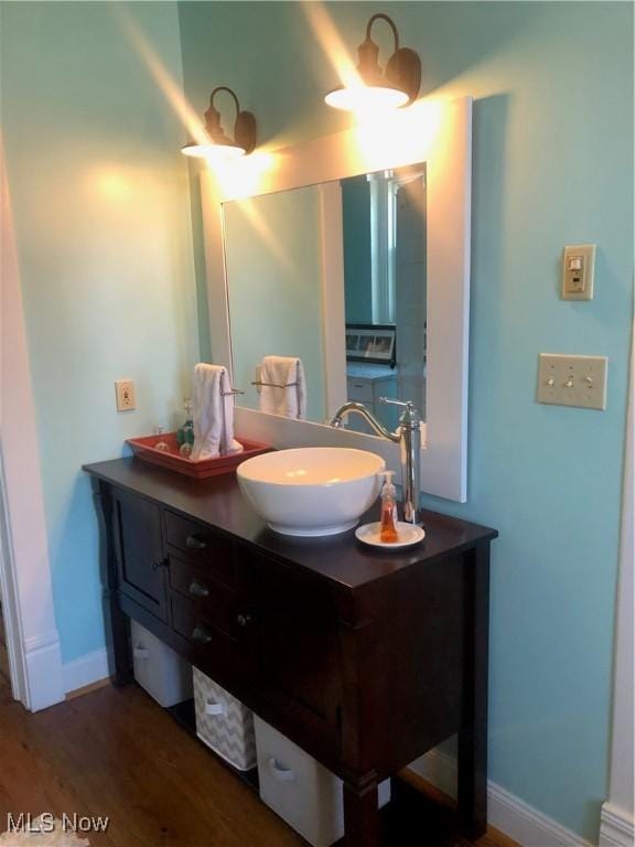 bathroom with hardwood / wood-style flooring and vanity