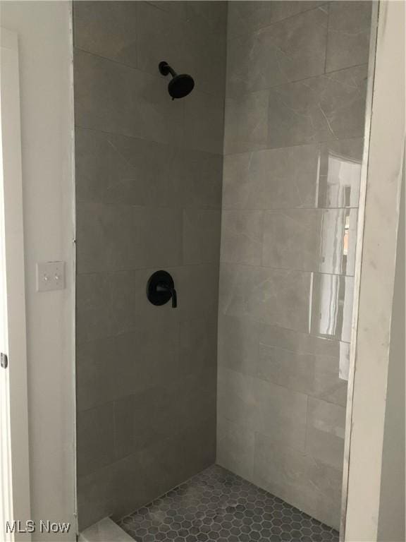 bathroom with a tile shower