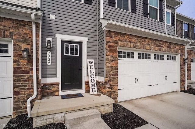 doorway to property with a garage