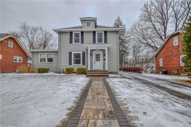 american foursquare style home with entry steps and cooling unit