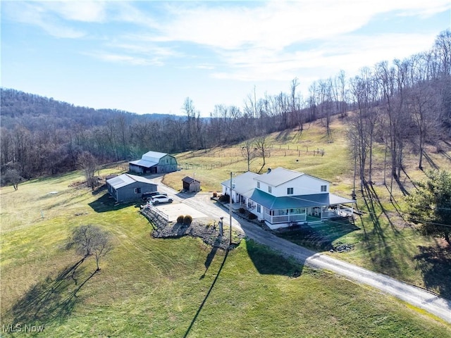 birds eye view of property with a rural view