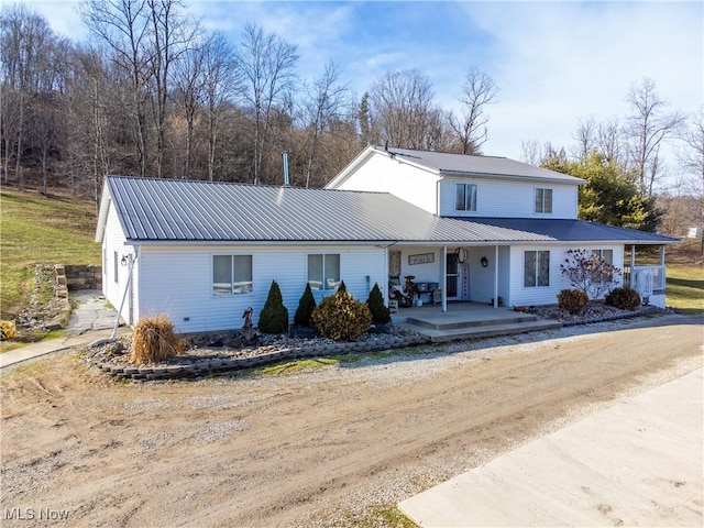 view of front of home with metal roof and a porch