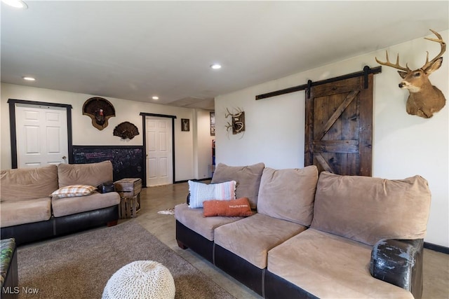 living area with a barn door and recessed lighting