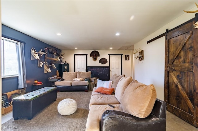 living room featuring recessed lighting, carpet flooring, and a barn door