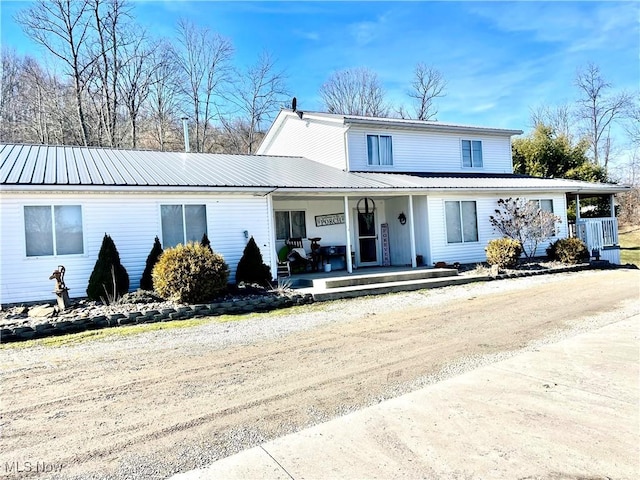 view of front of house featuring covered porch and metal roof