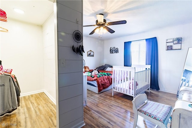 bedroom with baseboards and wood finished floors