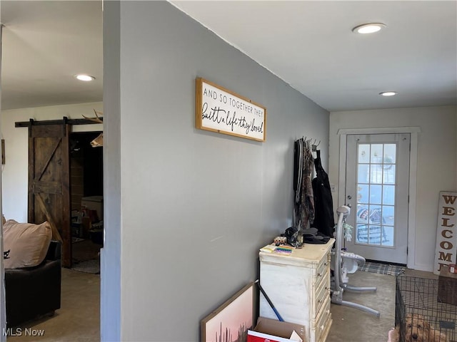 doorway to outside with a barn door and recessed lighting