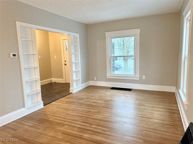 spare room with wood-type flooring