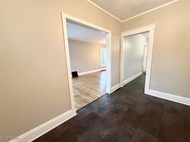 interior space with ornamental molding and a textured ceiling