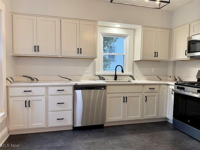 kitchen with white cabinetry, stainless steel appliances, and sink