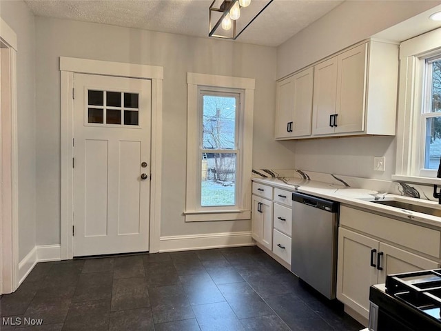 kitchen with white cabinetry, light stone countertops, sink, and stainless steel dishwasher