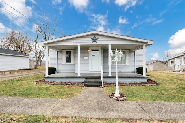 bungalow featuring a front lawn and covered porch