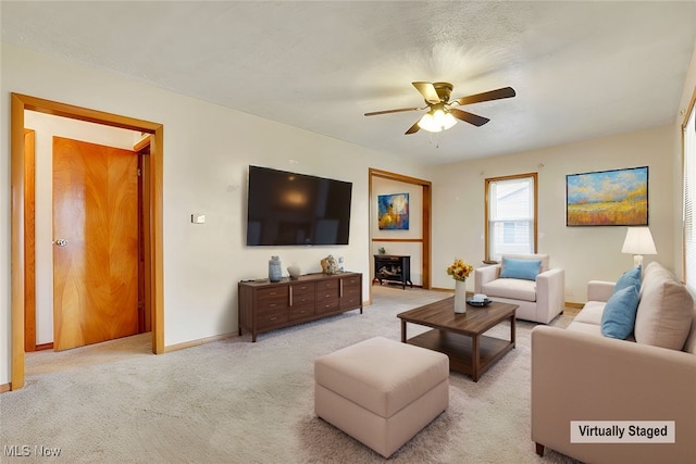 living room featuring ceiling fan and light carpet