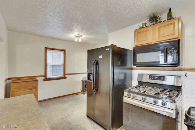 kitchen featuring light carpet, light brown cabinets, a textured ceiling, and black appliances