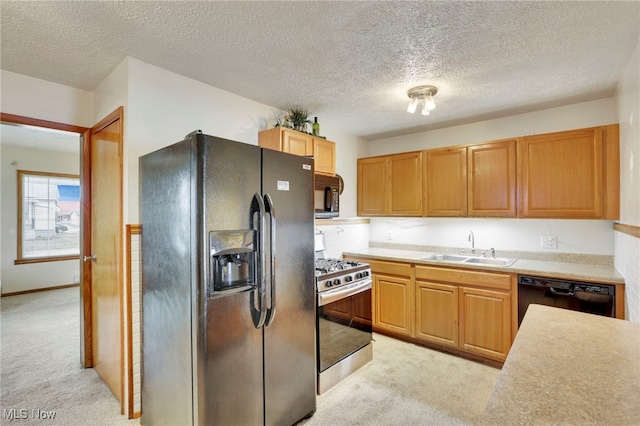 kitchen with sink, light carpet, a textured ceiling, and black appliances