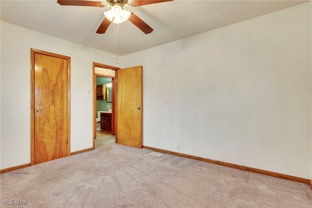 unfurnished bedroom featuring light colored carpet and ceiling fan