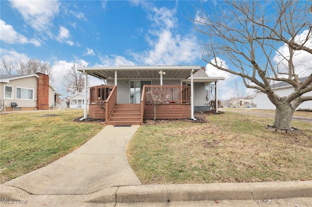 view of front facade with a front yard and a porch