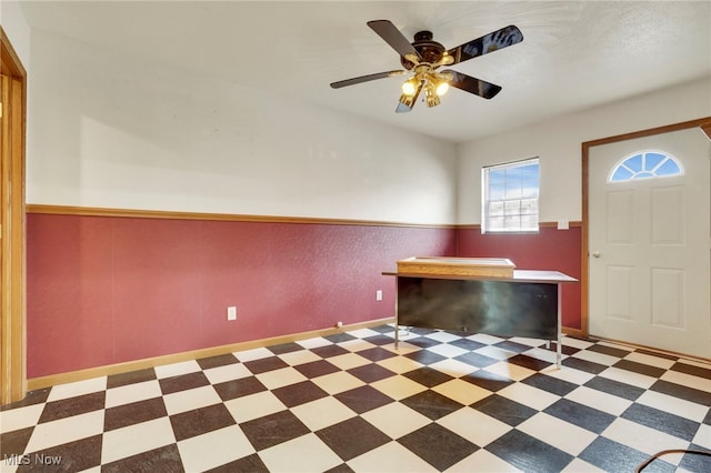 unfurnished office featuring ceiling fan