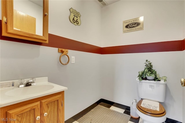 bathroom with vanity and toilet