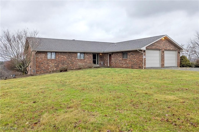 ranch-style home featuring a garage and a front lawn