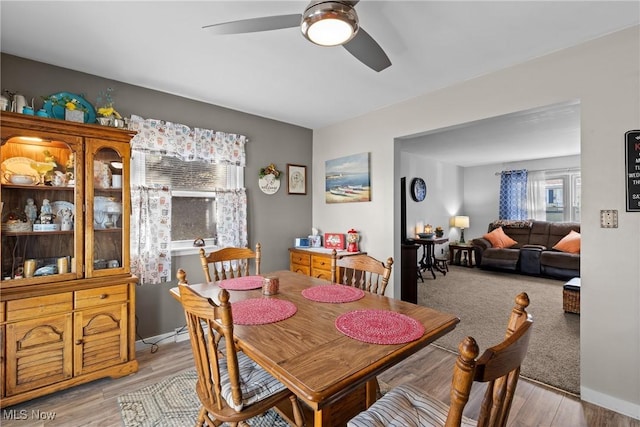 dining area featuring ceiling fan and light wood-type flooring