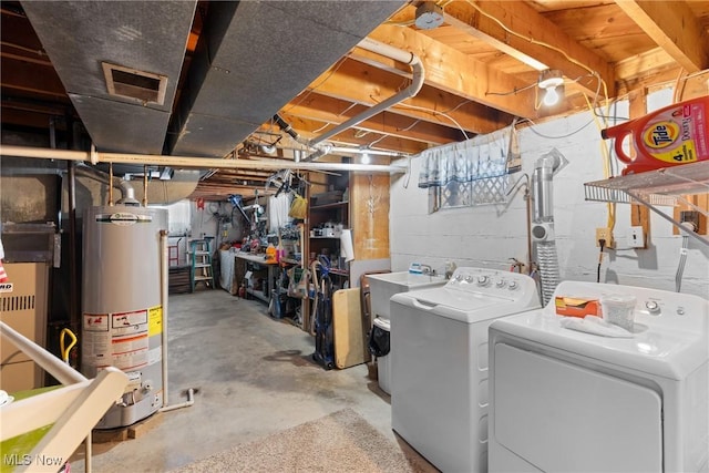 basement with water heater and independent washer and dryer