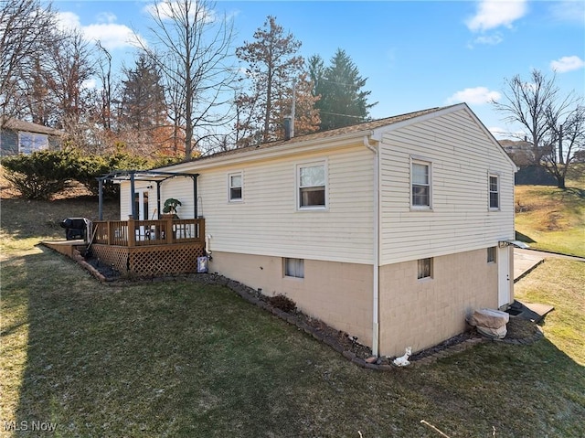 rear view of house with a yard, a pergola, and a deck