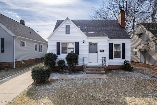 view of front of property with a chimney and roof with shingles