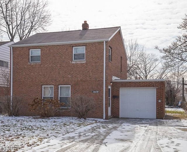 view of snowy exterior featuring a garage