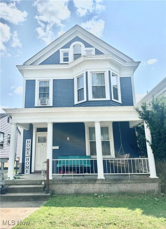 view of front of home featuring cooling unit and covered porch