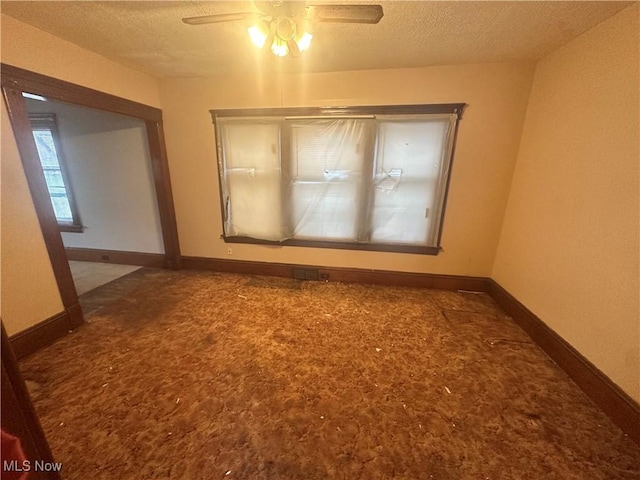 spare room with ceiling fan, carpet floors, and a textured ceiling