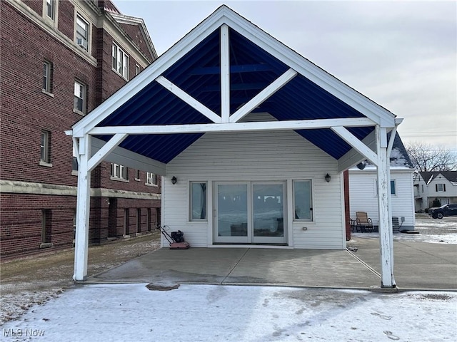 view of snow covered rear of property