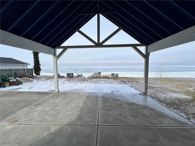 view of patio with a view of the beach and a water view