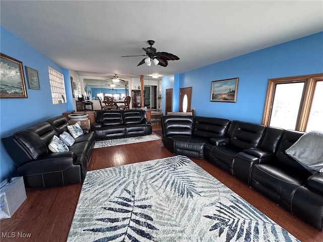 living room with dark hardwood / wood-style floors and ceiling fan