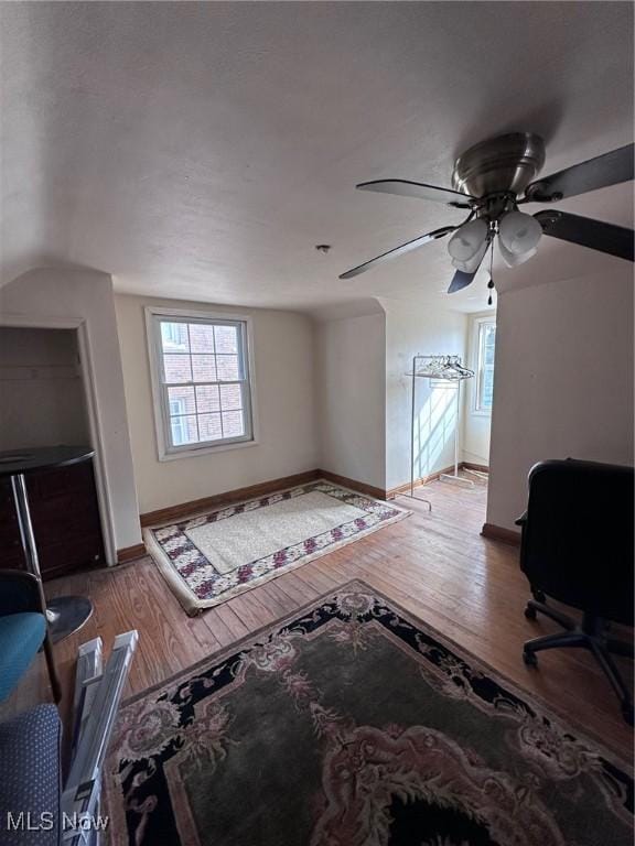 living room with hardwood / wood-style flooring and vaulted ceiling