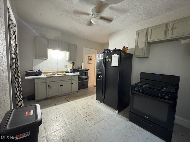 kitchen with gray cabinets, sink, ceiling fan, black appliances, and a textured ceiling