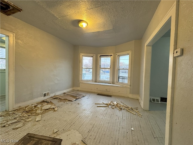 spare room with a textured ceiling