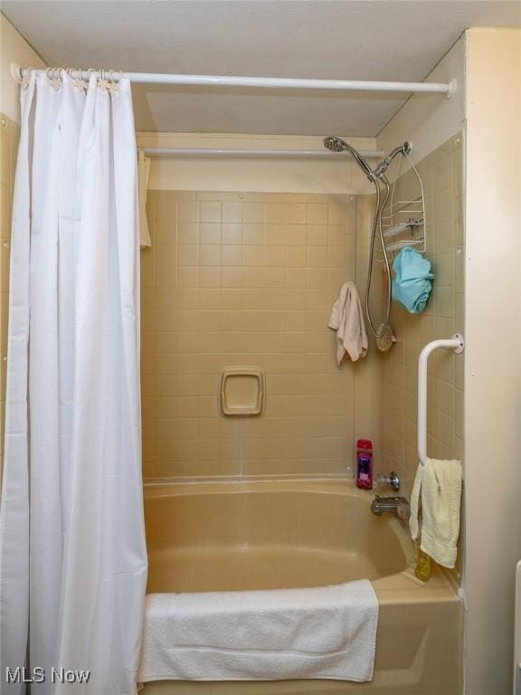 bathroom with shower / bath combination with curtain