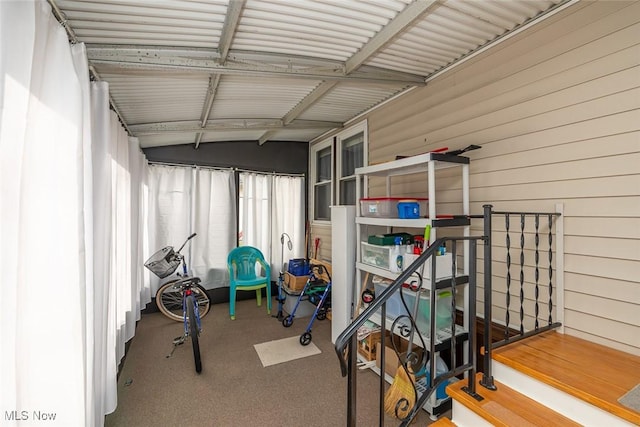 workout area featuring vaulted ceiling and carpet flooring