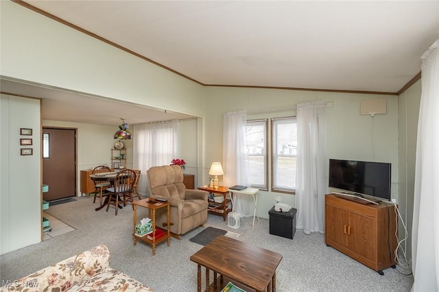 living room with lofted ceiling, light carpet, and ornamental molding