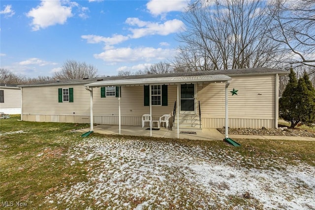 manufactured / mobile home featuring a yard and a patio area